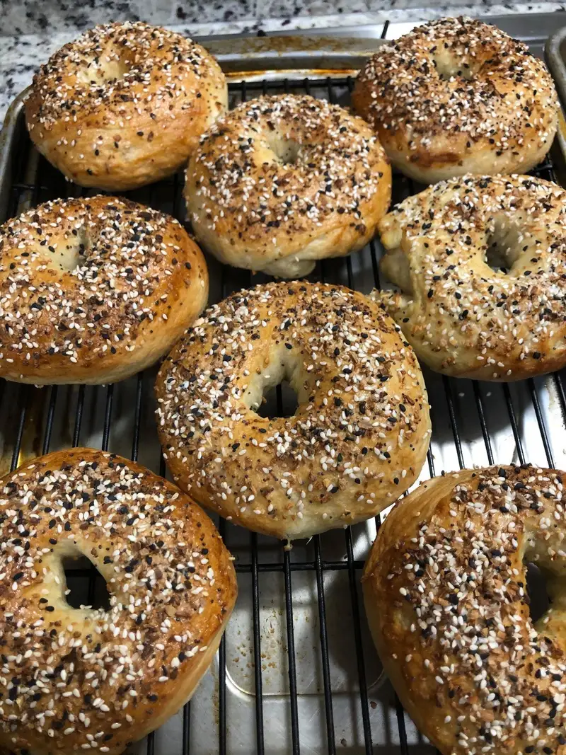 A tray of everything bagels fresh from the oven at The Bagel Lady