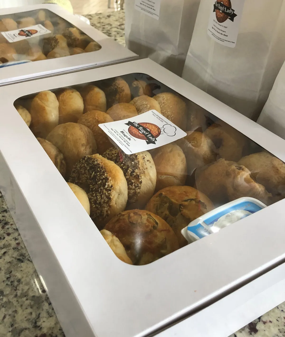 A catering board of assorted bagels with cream cheeses