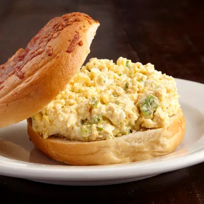 Egg salad piled on a fresh bagel