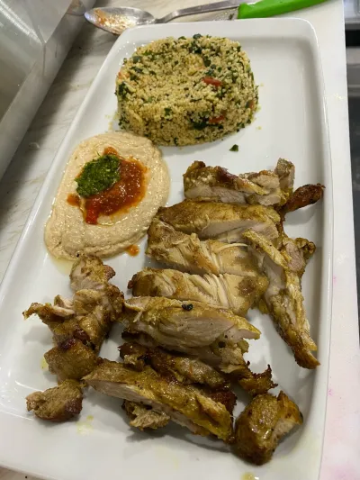 Grilled chicken platter with a stuffed bagel and tabouli