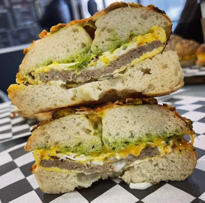 A sausage, egg and cheese bagel cut in half