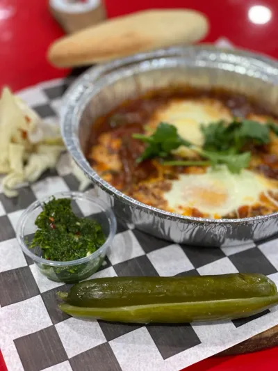 Shakshuka, eggs poached in tomato with herbs